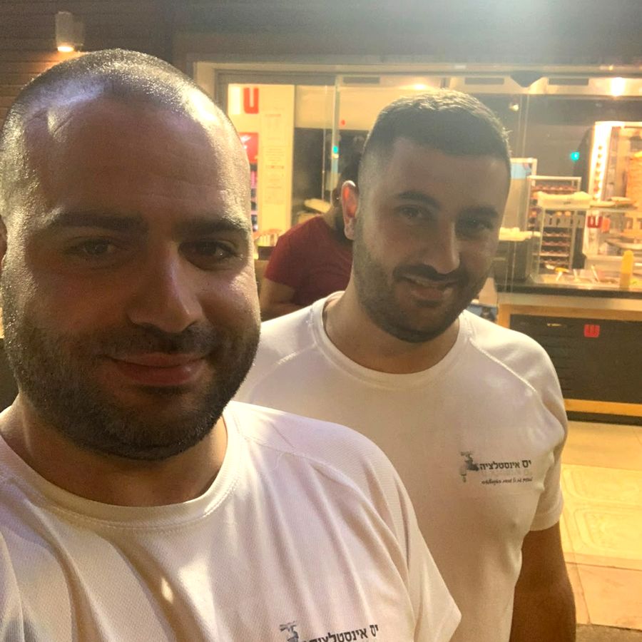 שני אינסטלטורים מצוות יס אינסטלציה בחולצות העסק